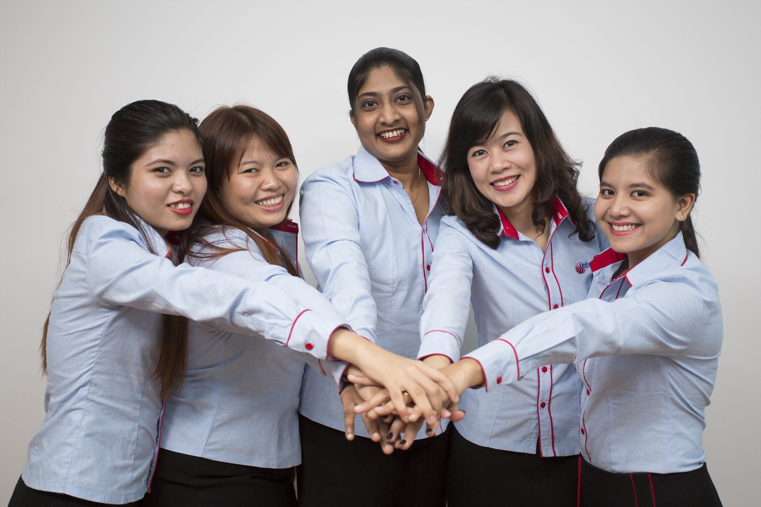 IGS Consulting colleagues with hands joined, marking the start of a new company